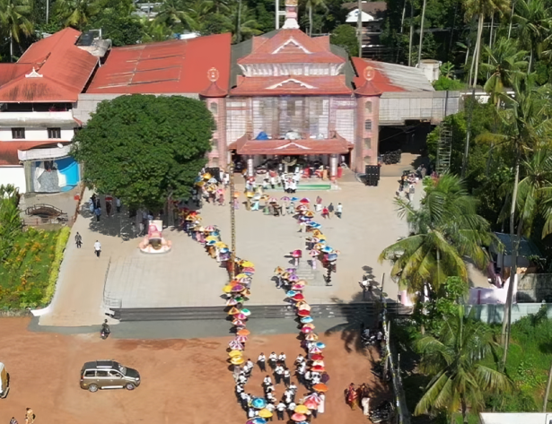 Devotees lighting massive beeswax candles during the Thiritheliyikkal ceremony at Holy Cross Shrine in Mapranam