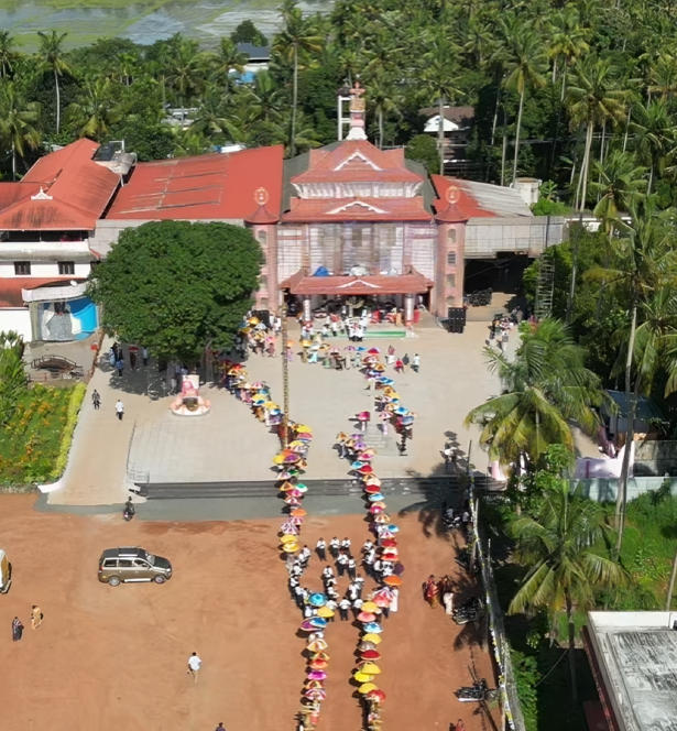 Devotees lighting massive beeswax candles during the Thiritheliyikkal ceremony at Holy Cross Shrine in Mapranam